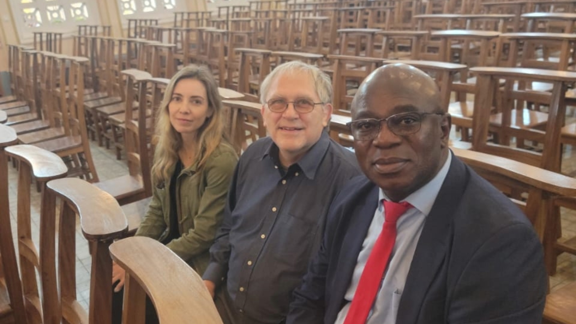 Dr. Itziar, Dr. Boivin, and Professor Desire Tshala-Katumbay pose for a selfie at a dedication service in Kinshasa, Democratic Republic of the Congo.