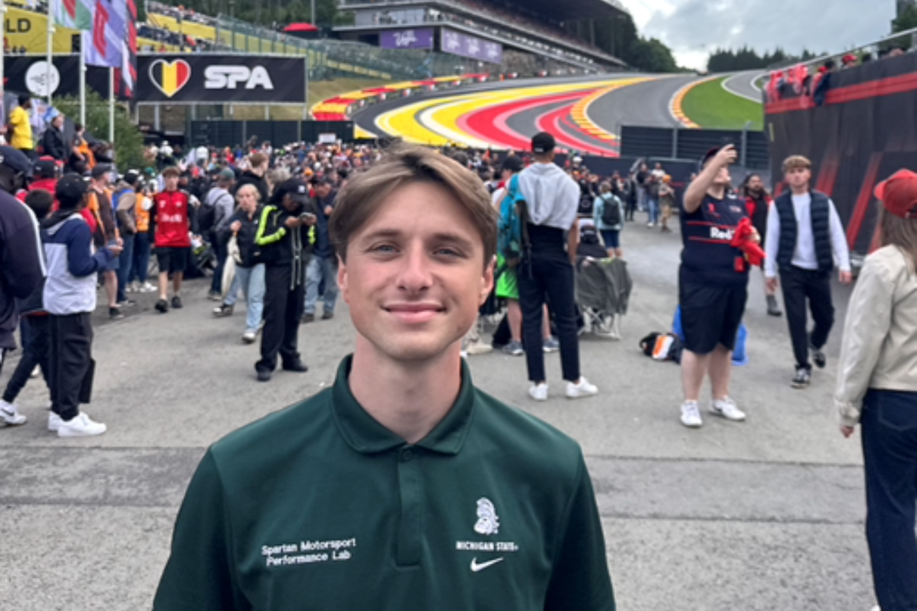 Student Aidan Davis smiling in a green polo at the 2025 Belgian Grand Prix