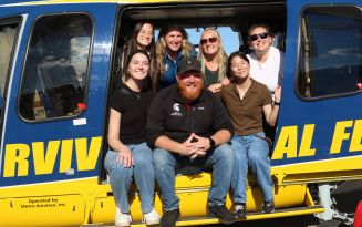 MSUCOM Emergency Medicine Club members sit inside the University of Michigan Health Survival Flight helicopter.
