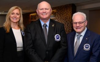 Three AOA board of trustee members in branded back suit jackets. Left to right: Kathleen S. Creason, Richard Thacker, Bruce Wolf
