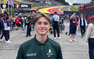 Student Aidan Davis smiling in a green polo at the 2025 Belgian Grand Prix