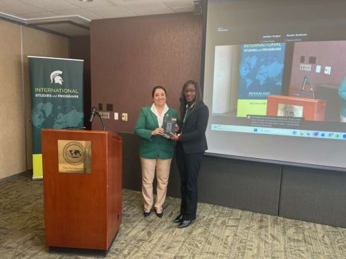 Farha Abbasi (left) and Amber Haque standing together holding their new book during a press release.
