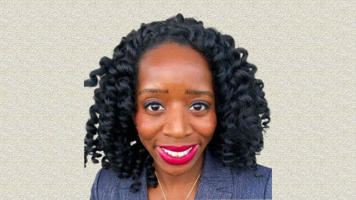 Headshot of author Bisi Alli, D.O., smiling in a light blue suit jacket in front of a textured tan background.